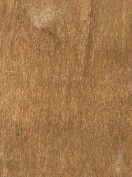 Brown wood texture with light spots of white paint and various dark blemishes and thin cracks.